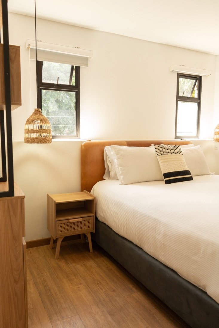 Hot Tub Room bedroom with a wood-slat headboard and warm lamp light