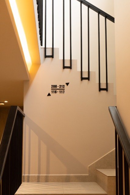 Guest room number signage on a wooden door