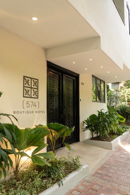 Lush garden walkway leading to the hotel entrance